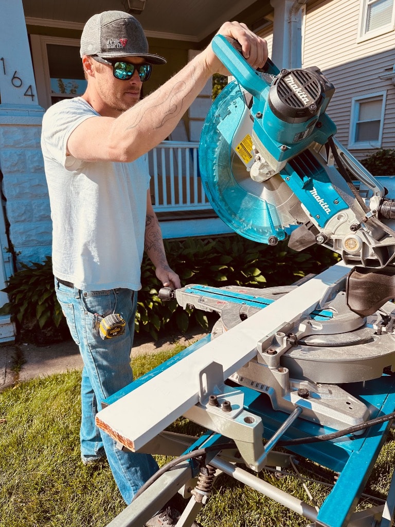Murray Brothers crew member cutting trim with a miter saw on a job site
