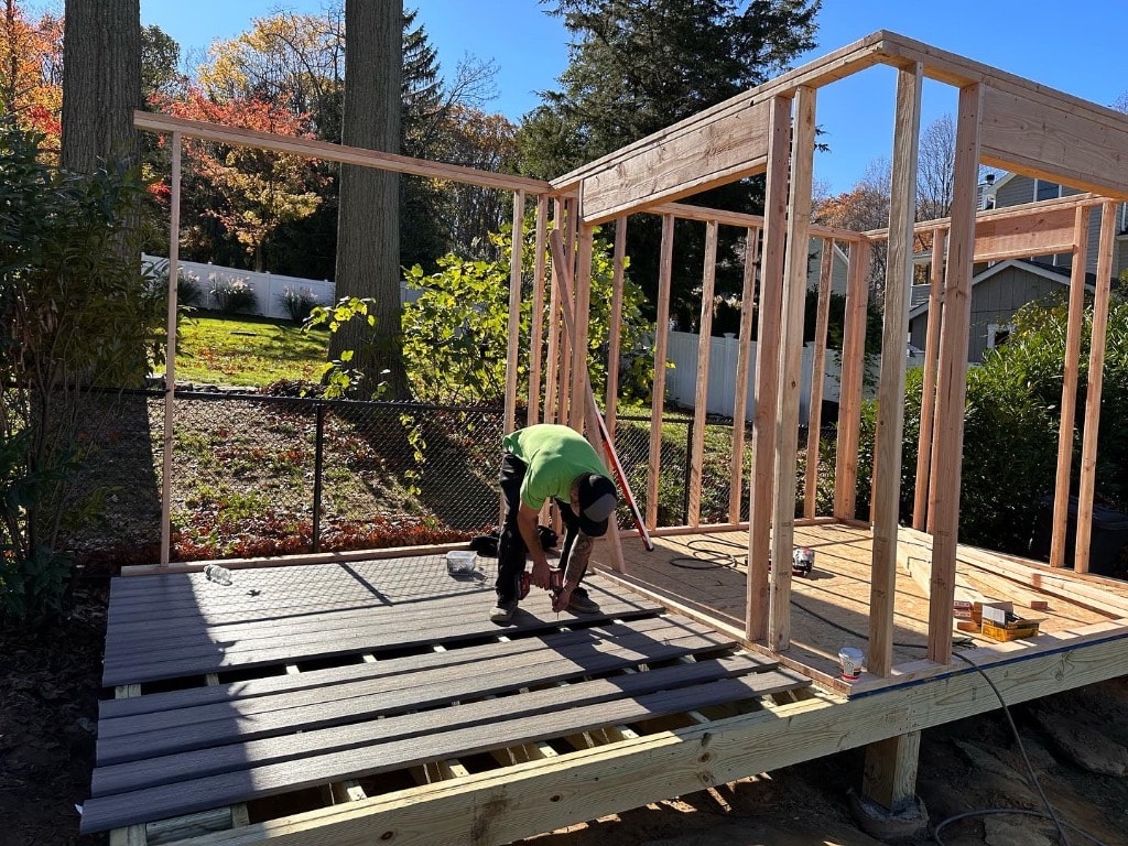 Murray Brothers crew installing composite decking boards on a residential deck