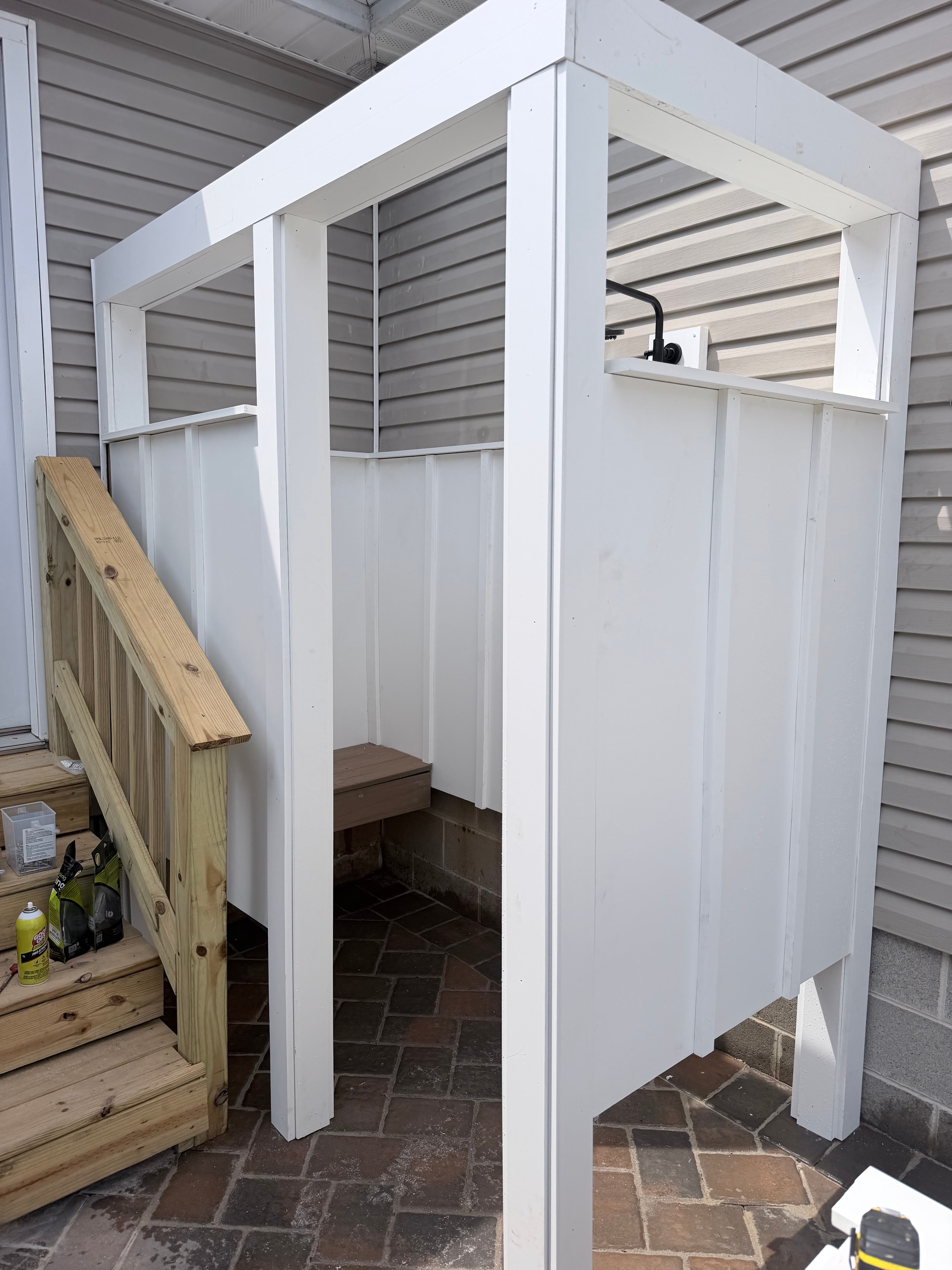 Murray Brothers outdoor shower enclosure under construction — white painted frame with pressure treated deck base