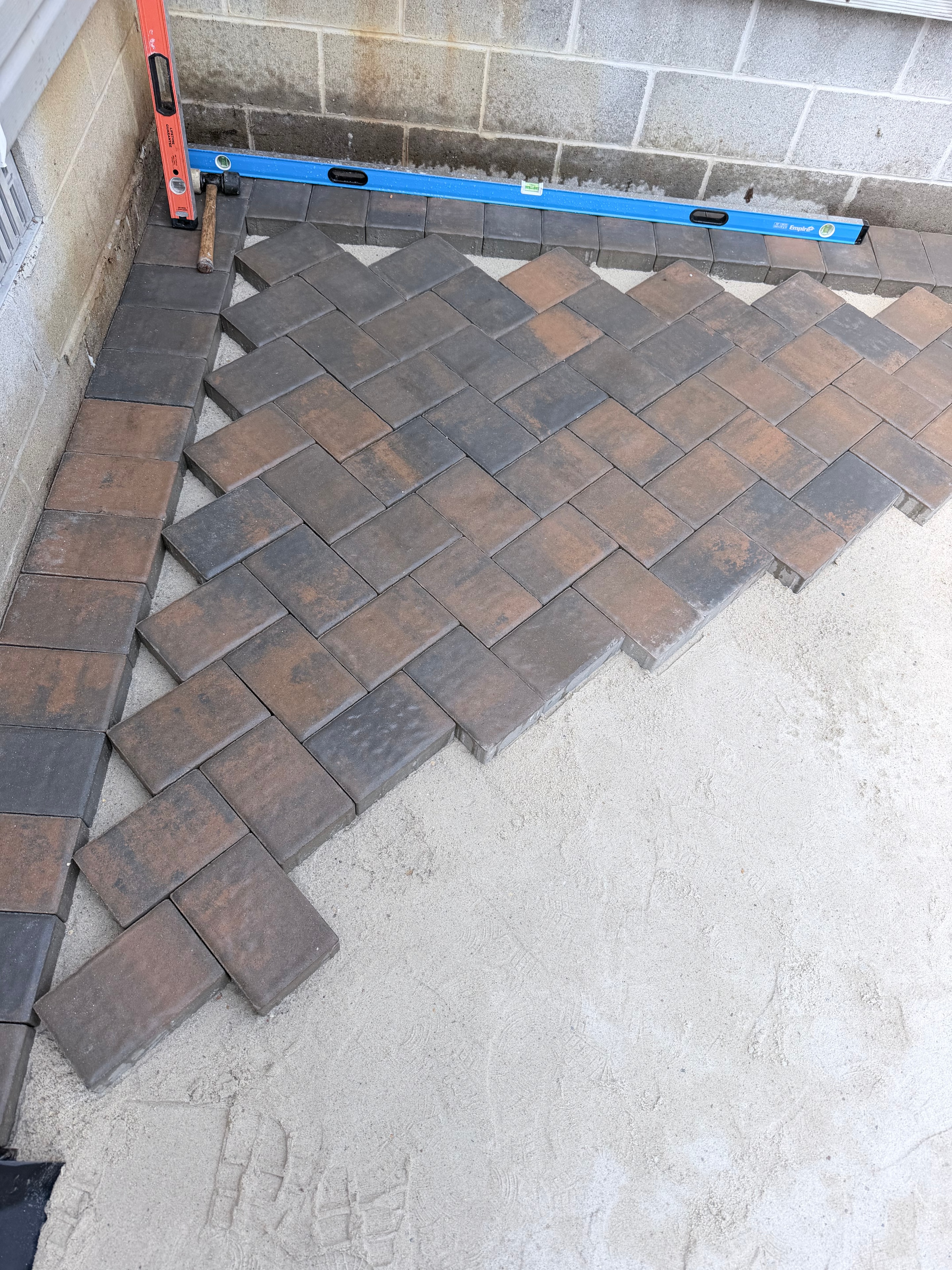 Close-up detail of herringbone brick paver patio by Murray Brothers